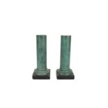 A PAIR OF GREEN MARBLEIZED COMPOSITE PILLARS OF PLAIN CYLINDRICAL FORM, raised on square platform