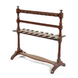 A VICTORIAN MAHOGANY BOOT RACK, raised on baluster turned and block side supports and splayed