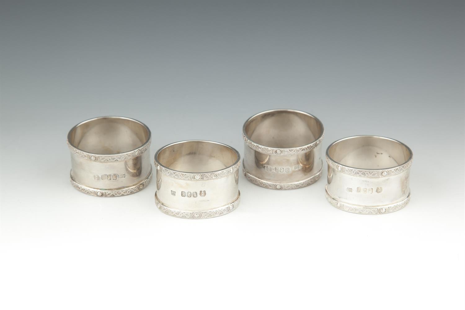 A SET OF FOUR MODERN IRISH SILVER NAPKIN RINGS, Dublin 1973, mark of Royal Irish Limited, with