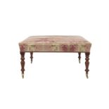 A LARGE UPHOLSTERED SQUARE STOOL the padded seat covered in pink silk damask and raised on turned