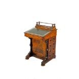A VICTORIAN INLAID WALNUT DAVENPORT DESK, the slope lift writing surface surmounted with a galleried