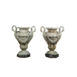 A PAIR OF CAST IRON GARDEN URNS of circular tapering form each with twin swan neck handles and