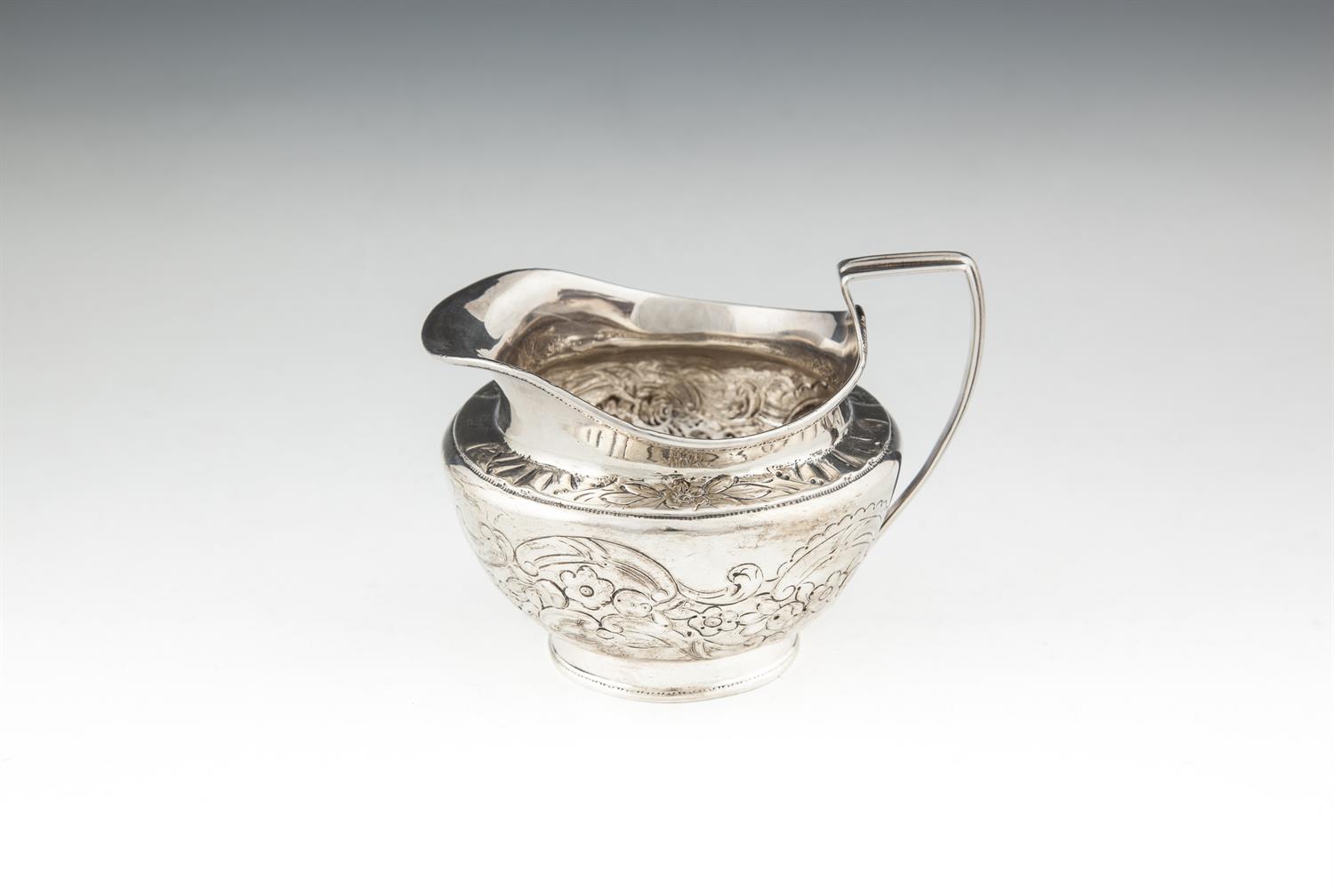 A LATE GEORGE III IRISH SILVER CREAM JUG, Dublin 1807, mark of James Scott, of circular baluster