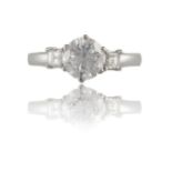 A DIAMOND SINGLE-STONE RINGSet with a round brilliant-cut diamond, between square-cut diamond