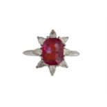 A RUBY AND DIAMOND CLUSTER RINGThe cushion-shaped ruby weighing 3.01cts, in a eight-claw setting,