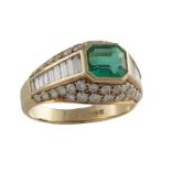 ***WITHDRAWN***AN EMERALD AND DIAMOND RINGThe collet-set emerald, within a baguette-cut and