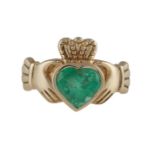AN IRISH CLADDAGH EMERALD RINGThe collet-set heart-shaped emerald, mounted in 14K gold, ring size