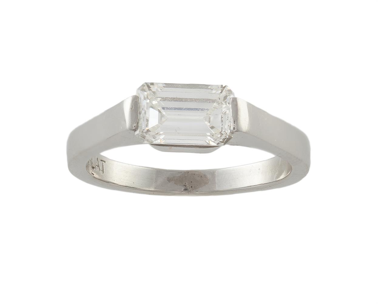 A DIAMOND SINGLE-STONE RINGThe rectangular step-cut diamond, set horizontally to the centre,