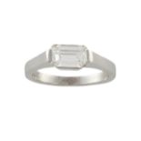 A DIAMOND SINGLE-STONE RINGThe rectangular step-cut diamond, set horizontally to the centre,