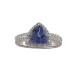 A TANZANITE AND DIAMOND RINGThe trilliant-cut tanzanite, within a diamond pavé-set surround, mounted