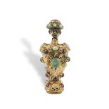 AN UNUSUAL GILT METAL AND JEWELLED FIGURAL SCENT BOTTLE, probably 18th century, the stopper