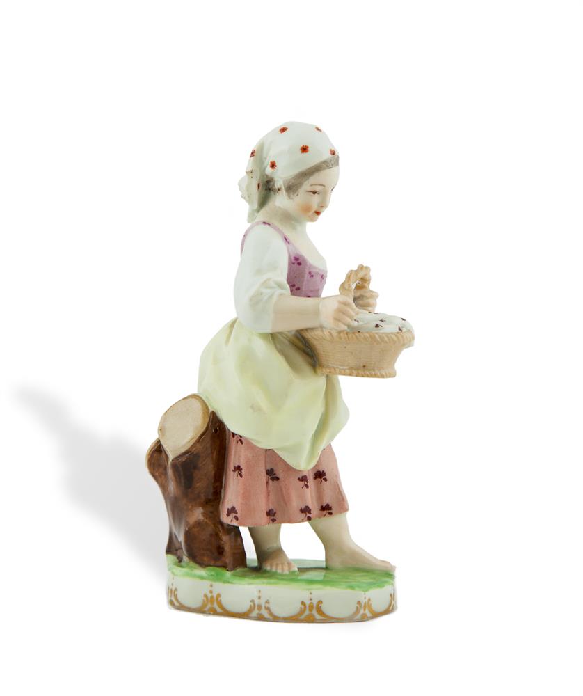 AN 18TH/19TH CENTURY AUSTRIAN PORCELAIN FIGURE, Vienna, modelled as a young girl holding a wicker