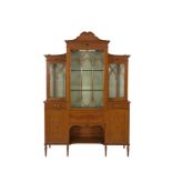 A LATE VICTORIAN INLAID SATINWOOD BREAKFRONT DISPLAY CABINET, by Maple & Co.,Tottenham Court Road,