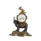 A FRENCH GILT METAL AND BRONZE MANTLE CLOCK, in the form of an elephant carrying the drum cased