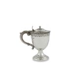 AN IRISH VICTORIAN SILVER CIRCULAR LIDDED CUP, Dublin 1866, the hinged flat domed lid with shell