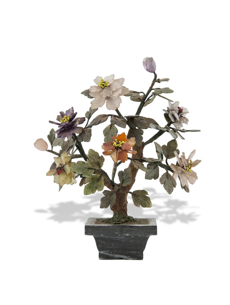 A 20TH CENTURY JAPANESE COLOURED HARDSTONE MODEL OF A BONSAI TREE, set in a polished stone