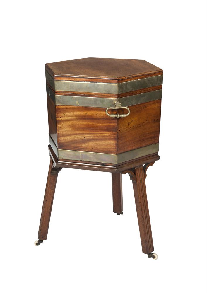 A GEORGE III MAHOGANY HEXAGONAL LIDDED BRASS BOUND WINE COOLER/CELLARETTE, the interior with zinc