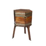 A GEORGE III MAHOGANY HEXAGONAL LIDDED BRASS BOUND WINE COOLER/CELLARETTE, the interior with zinc