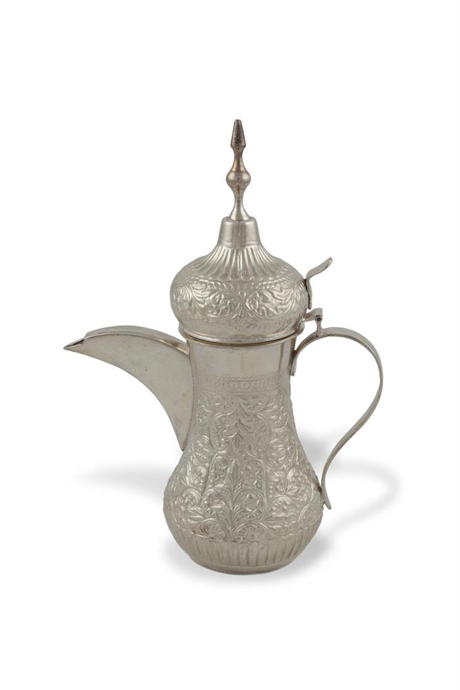 A MID-EASTERN WHITE METAL COFFEE POT, the domed lid with spire finial above a 'C' scroll handle