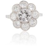 A DIAMOND CLUSTER RINGThe round brilliant-cut diamond, weighing approximately 0.70ct, within a