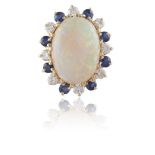 AN OPAL, DIAMOND AND SAPPHIRE CLUSTER RINGThe oval-shaped opal, within a surround of round-shaped