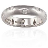 A DIAMOND-SET ETOILE ETERNITY RING, BY TIFFANY & CO.The polished band set with round brilliant-cut