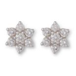 A PAIR OF DIAMOND EAR STUDSEach centred by a round brilliant-cut diamond, to a surround of