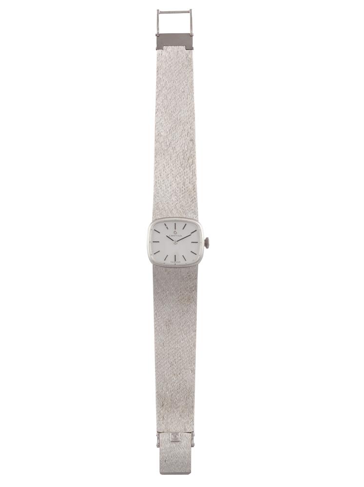 A LADY'S 18K GOLD MANUAL WIND BRACELET WATCH, BY CERTINA, CIRCA 1960The cushion-shaped silvered