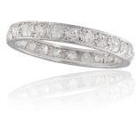 A DIAMOND ETERNITY RINGComposed of a continuous row of old brilliant-cut diamonds, each in a four-