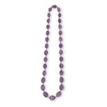 A LATE VICTORIAN AMETHYST NECKLACE, CIRCA 1900The graduated oval-cut amethysts each mounted in an