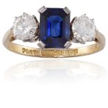 A SAPPHIRE AND DIAMOND RINGThe octagonal-cut sapphire in a four-claw setting, between two round