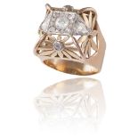 A DIAMOND DRESS RINGOf square bombé design, set with a central round brilliant-cut diamond within