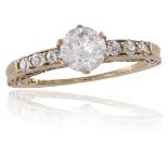 A DIAMOND SINGLE-STONE RINGThe round brilliant-cut diamond, between old brilliant-cut diamond