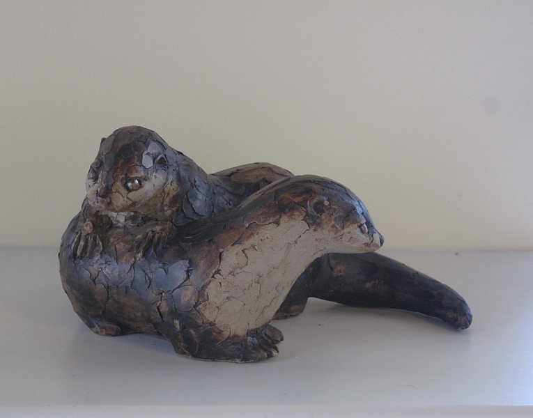 Tom Mullaney, Irish School, a pottery figure of two otters, 28 cm wide, 12.5 cm high.