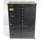 39. An early 20th century painted deal optician's counter-top chest, fitted twelve long drawers with