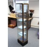 15. A brass-frame  narrow upright display cabinet with four adjustable plate glass shelves; 60½"
