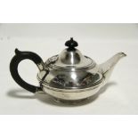 A late Victorian bachelor teapot of squat round form with domed hinged lid & on rim foot; London