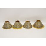 A set of four Gorham Co. sterling pierced conical lamp shades decorated with anthemions, urns,