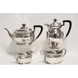 A George V four-piece tea service of plain squat oval form, including a hot water jug; Sheffield