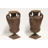 A pair of 19th century Austrian bronzed pottery neo-classical vases by W. Schiller, having chamois