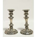 A pair of George IV candlesticks with removable drip pans, slender baluster columns, & shaped