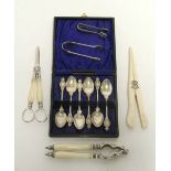 A matching pair of nut-crackers & grape scissors with ivory handles; a set of six George VI