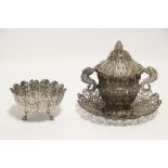 An Indian white metal fluted deep bowl with petal-shaped rim, all-over chased with leaf-scrolls, &