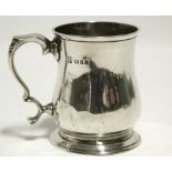 A mid-18th century style baluster half-pint tankard with scroll handle, 3¾” high; London 1926, by J.