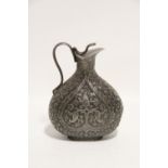 AN INDIAN WHITE METAL EWER, the flat-sided pear shaped body chased with stylised flowers, having
