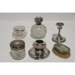 An Edwardian cut-glass spherical toilet water bottle with embossed silver round cover, 5” high,