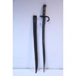 A late 19th century French chassepot bayonet with 22½” long single-edge curved blade, brass grip &