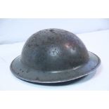 A WWII British safety helmet with chin-strap.