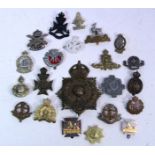Thirty various British military cap badges, & various ditto tunic buttons.