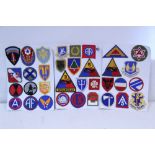 Thirty-four various cloth badges, mounted, un-framed.